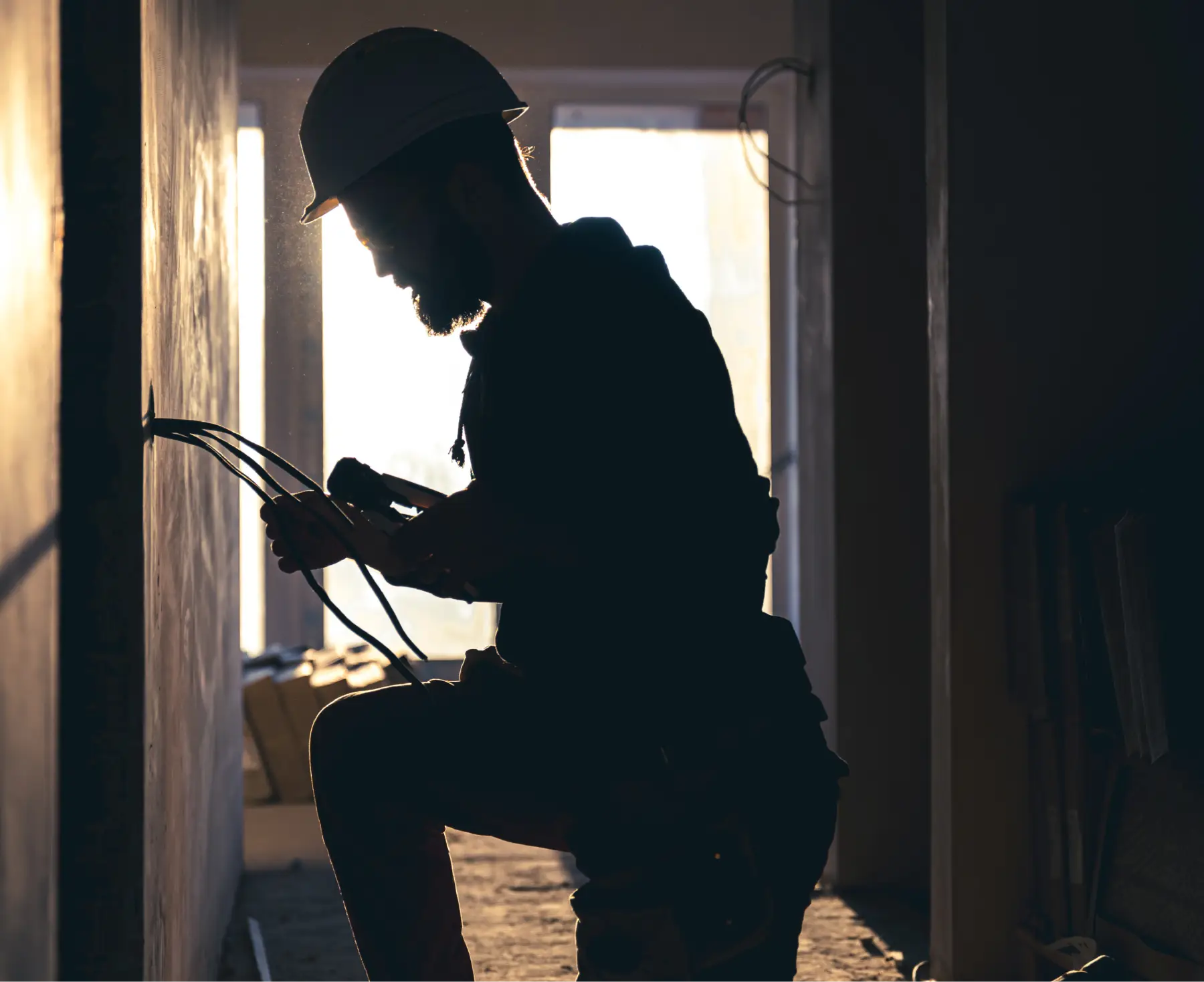 Worker is cutting wires with pliers